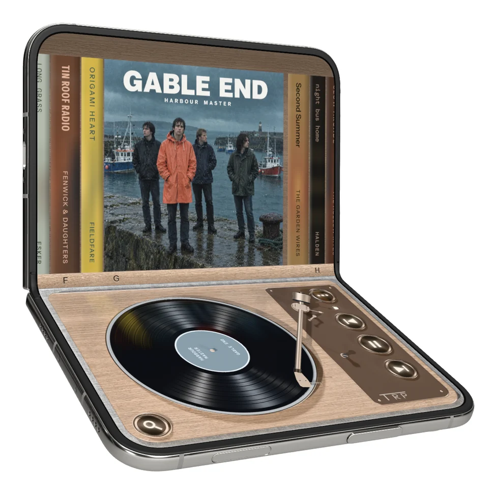 The shelf of albums on iPhone Duo, one sleeve pulled out, above the turntable